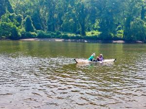 Lupu kayaking on the Anacostia with Simcha, white Swiss shepherd